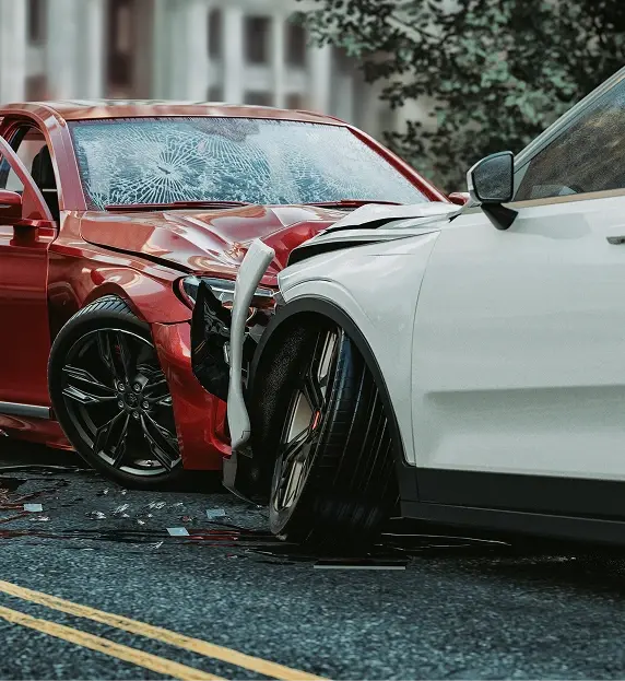 Red sedan and white SUV collided on road, with shattered windshield and significant front damage on both vehicles